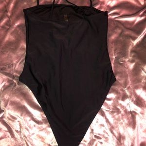 Never worn- simple black one piece swimsuit